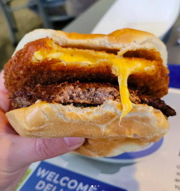 The CurderBurger from Culvers shows off its gooey cheese curd patty and the juicy meat patty.