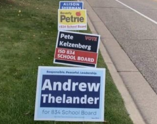 campaign signs on side of road