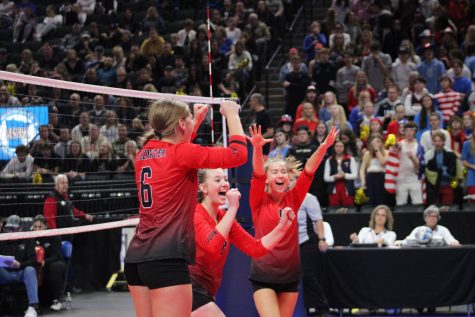 volleyball team huddles and cheers