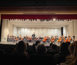 Students playing in orchestra concert.