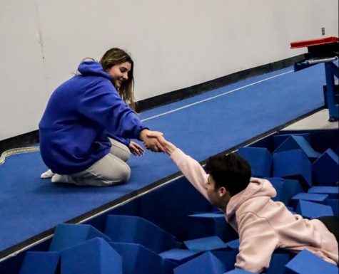 Senior general education student Leah Foster and special education student play in the foam pit. During Unified PE, the students are paired together to work together in many different types of activities.