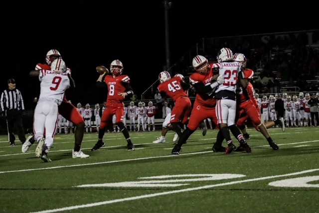 Quarterback Max Shikenjanski throwing a pass to a receiver