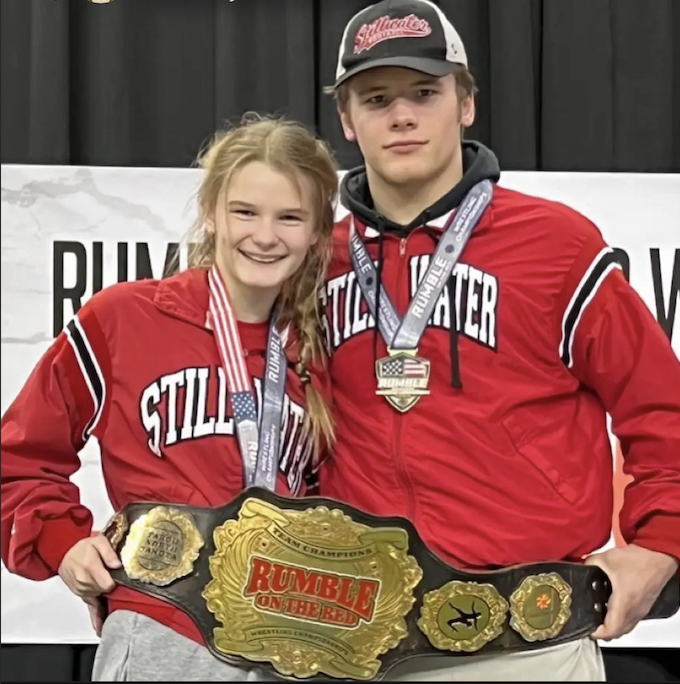 Freshman Audrey Rogotzke and senior Ryder Rogotzke with thier wrestling 2022 State Championshiop belt. Audrey and Ryder have made Minnesota history by being the first sibling duo to win the boys and girls State wrestling championship title. 