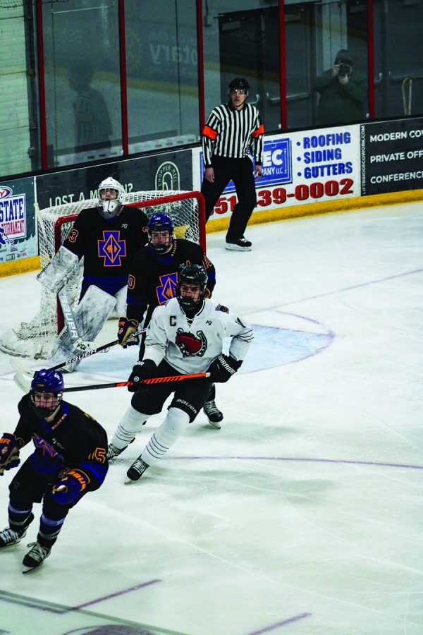 Ty Tuccitto forechecks in the offensive zone against Cretin Derham-Hall on Feb. 9. The game ended in a winning score of 6-2, thus redeeming the ponies from their last game against Cretin Derham-Hall.