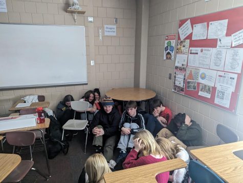 Students hiding in the corner of a classroom.