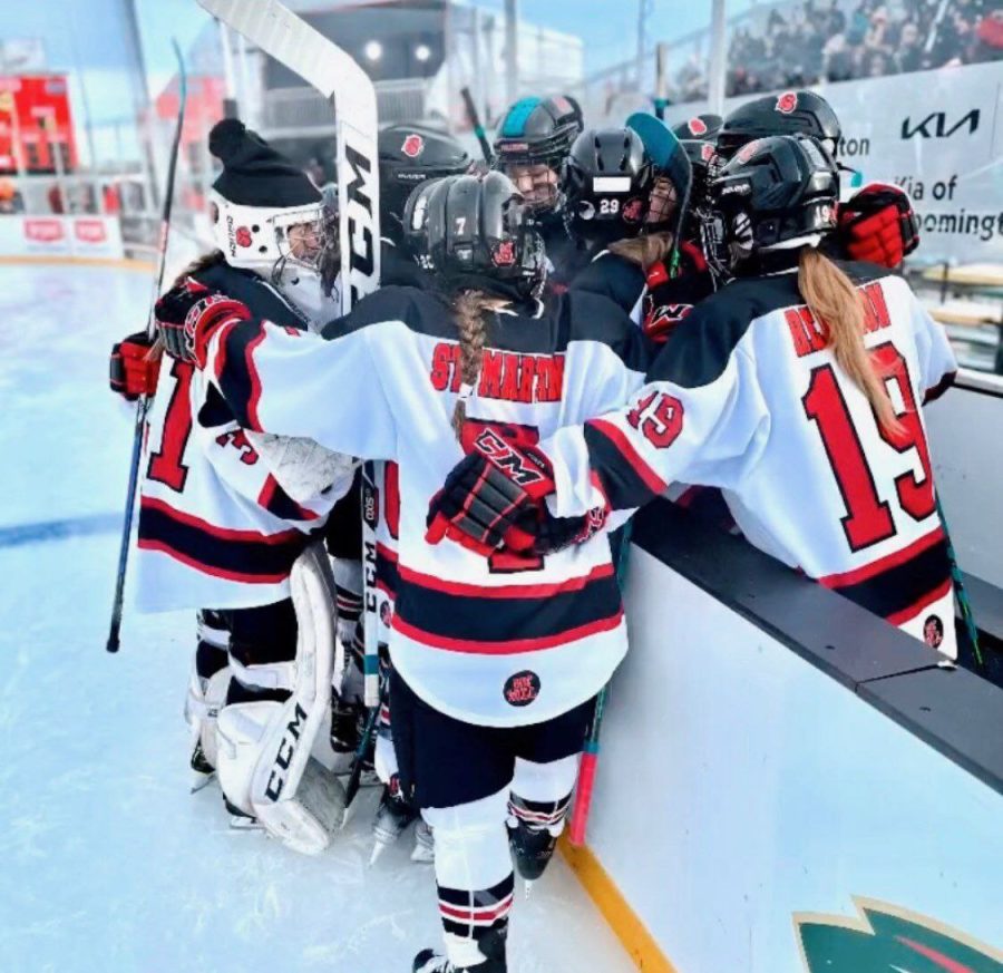 The+girls+hockey+team+huddles+together+during+a+media+break+at+their+game+at+Hockey+Day+Minn.%2C+Jan.+28.