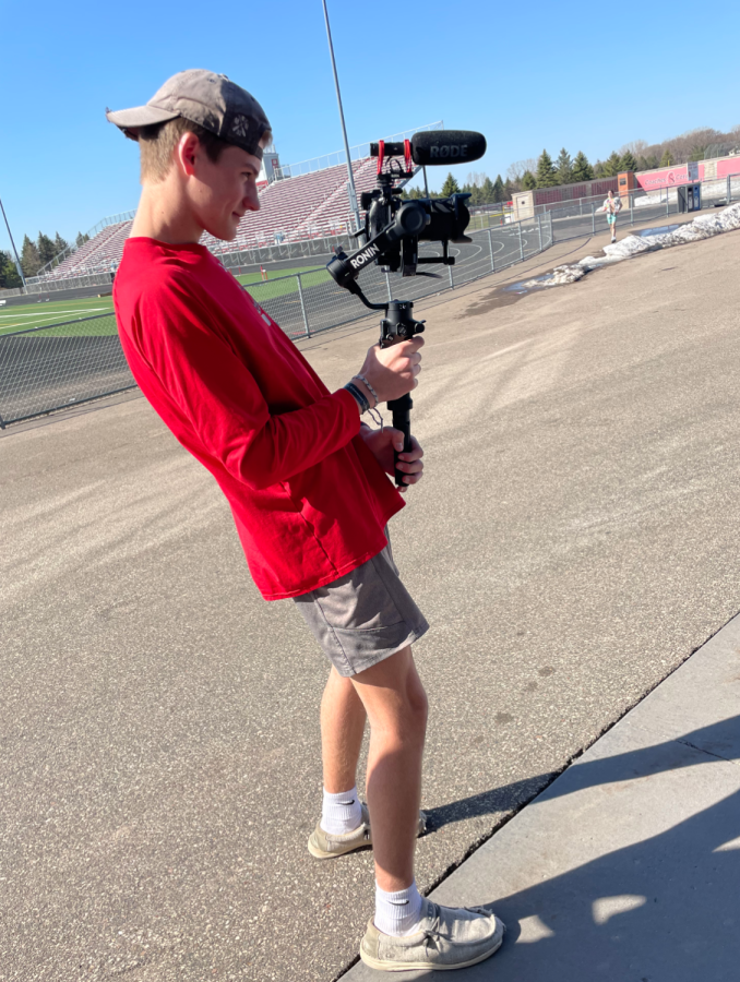 Junior Oren Hamilton filming with his new camera at the high school.
