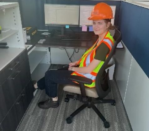 Senior Isabelle Knighton sits at her desk in the office of her internship. At her internship, she works as a civil engineer in the transport division for Washington County.