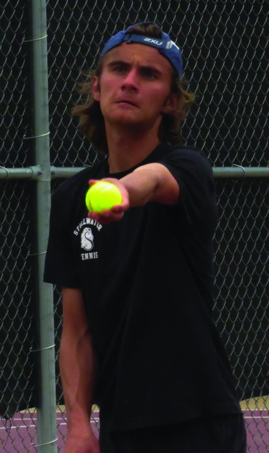 Senior Brady Lau is about to throw the ball up for a serve. This was on may 12 at home for a match against White Bear. 