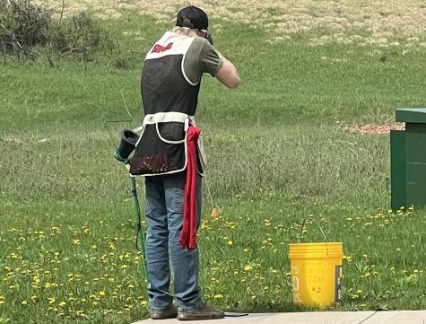 A person who is shooting a clay target out of the air.