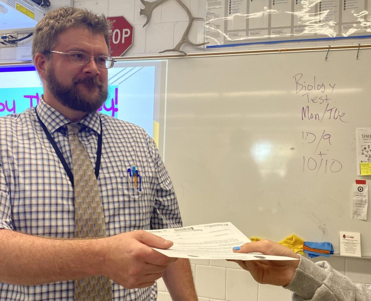 New AP environmental science teacher Peter Stenross hands out papers to students. Stenross is new AP environmental science teacher replaced Andy Weaver after he retired this last spring.