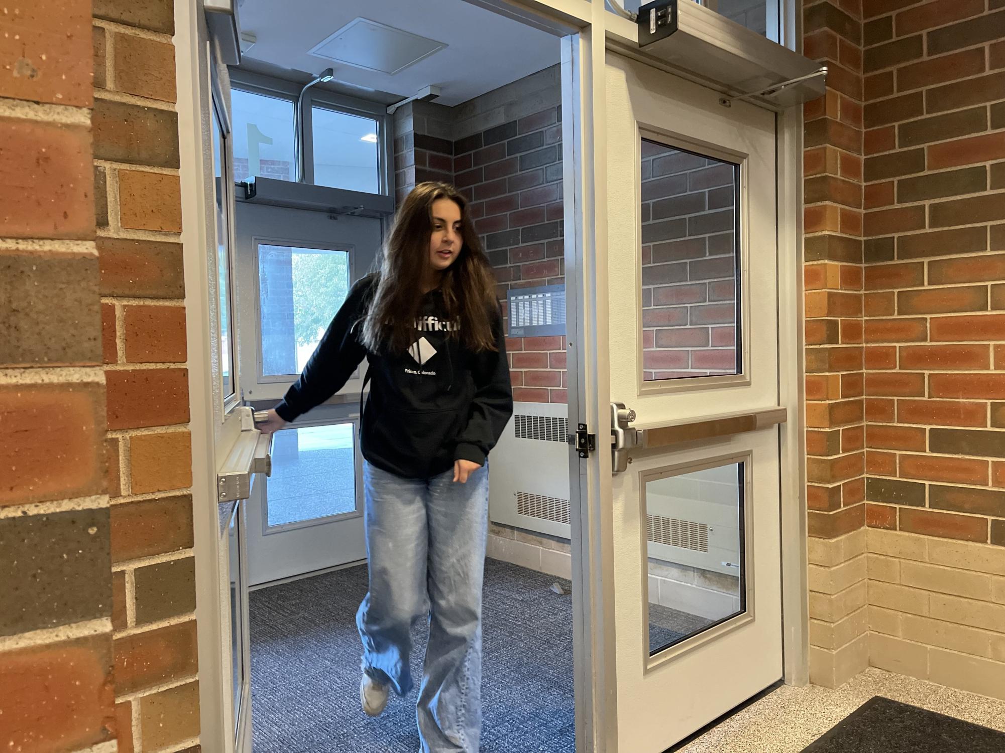Senior Marissa Fasick walks into school before the start of the second hour as her first hour is senior elect. Seniors can utilize senior elect to reduce their daily schedule.
