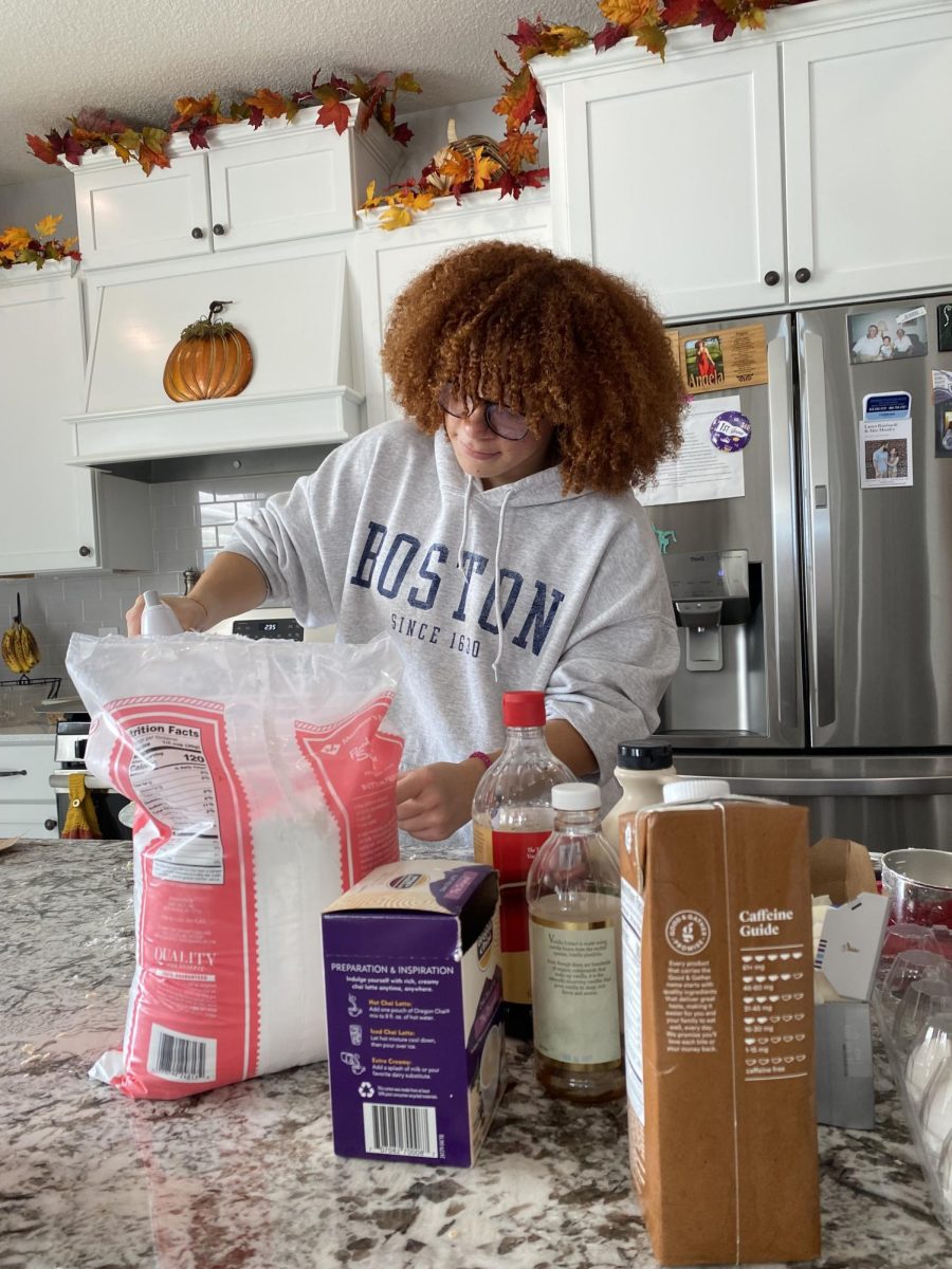 Senior Angela working from home on icing for her newest addition for her cupcake line up pumpkin chai. Taylor goes home every day and works on new creations to add to her instagram page.