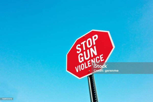 Stop gun violence sign pin front of a blue sky. A simple message to stop gun violence across the country and also the world. With restricted gun laws gun violence will decrease across the country
