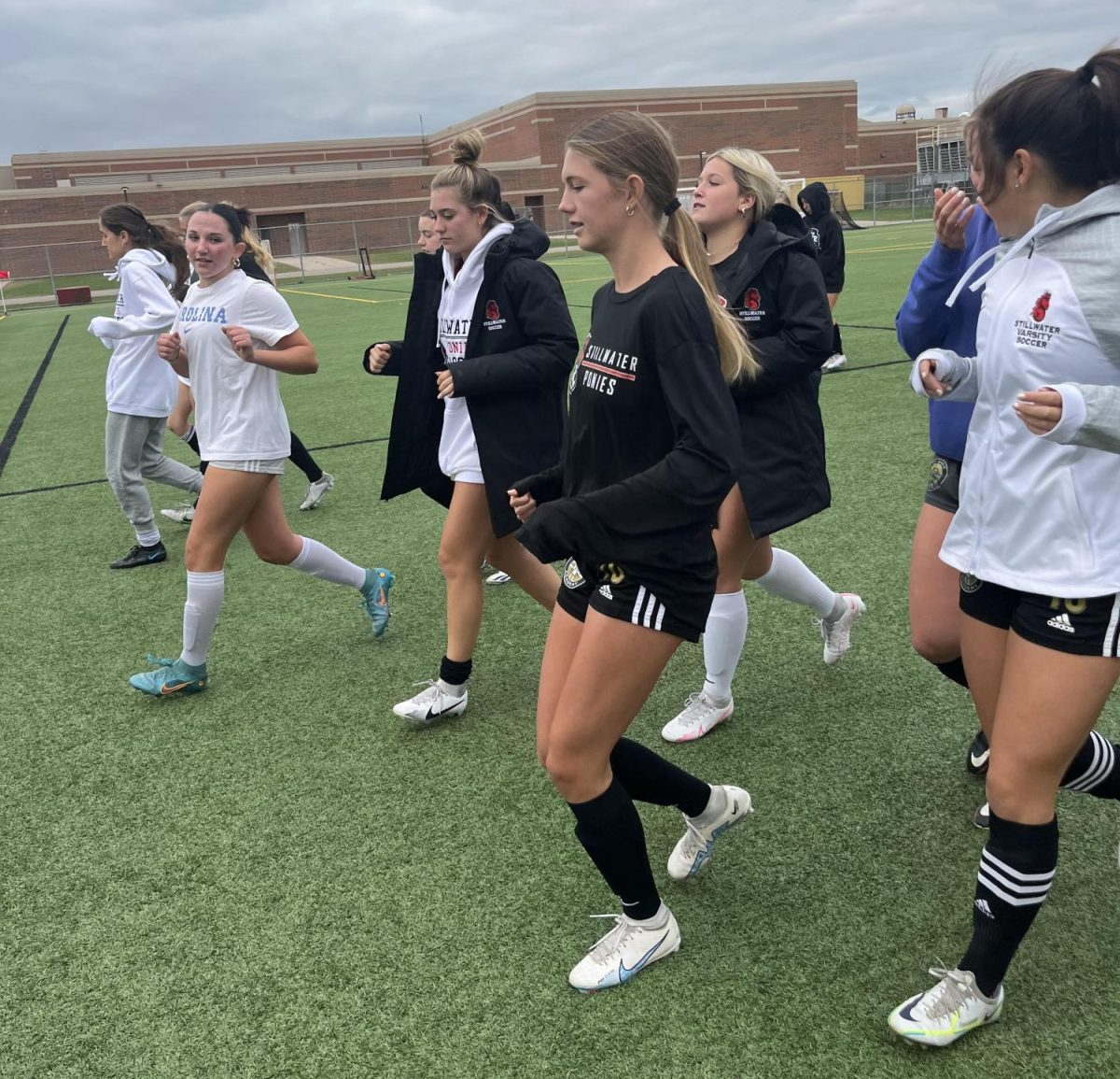 The girls soccer team warms up before their practice. Coaches Mike Huber and Dusty Dennis rebuilding the varsity girls soccer team after graduating 11 seniors in the class of 2022.
