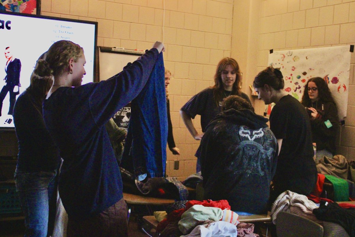 The Sustainable Fashion Club holds a clothing swap. Students engage in socializing with peers getting new clothes in an eco-friendly way.