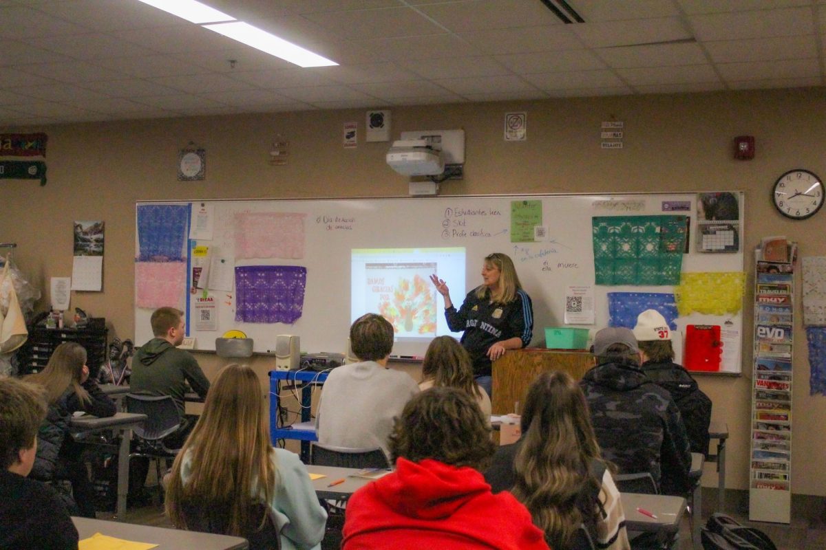 Spanish teacher Kirsten Carter talks to her Spanish 2 class about making a large class hand turkey for the wall. The class will write in Spanish what they are grateful for on a colored hand that will be placed on the turkey. 