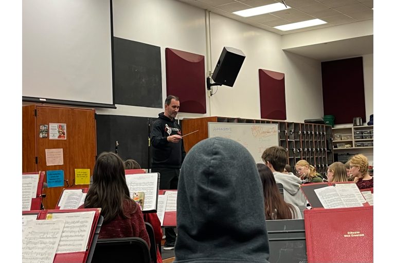 Band director Tark Katzenmeyer teaches a band class. The previous director has chosen to step down and Katzenmeyer has risen to the challenge.