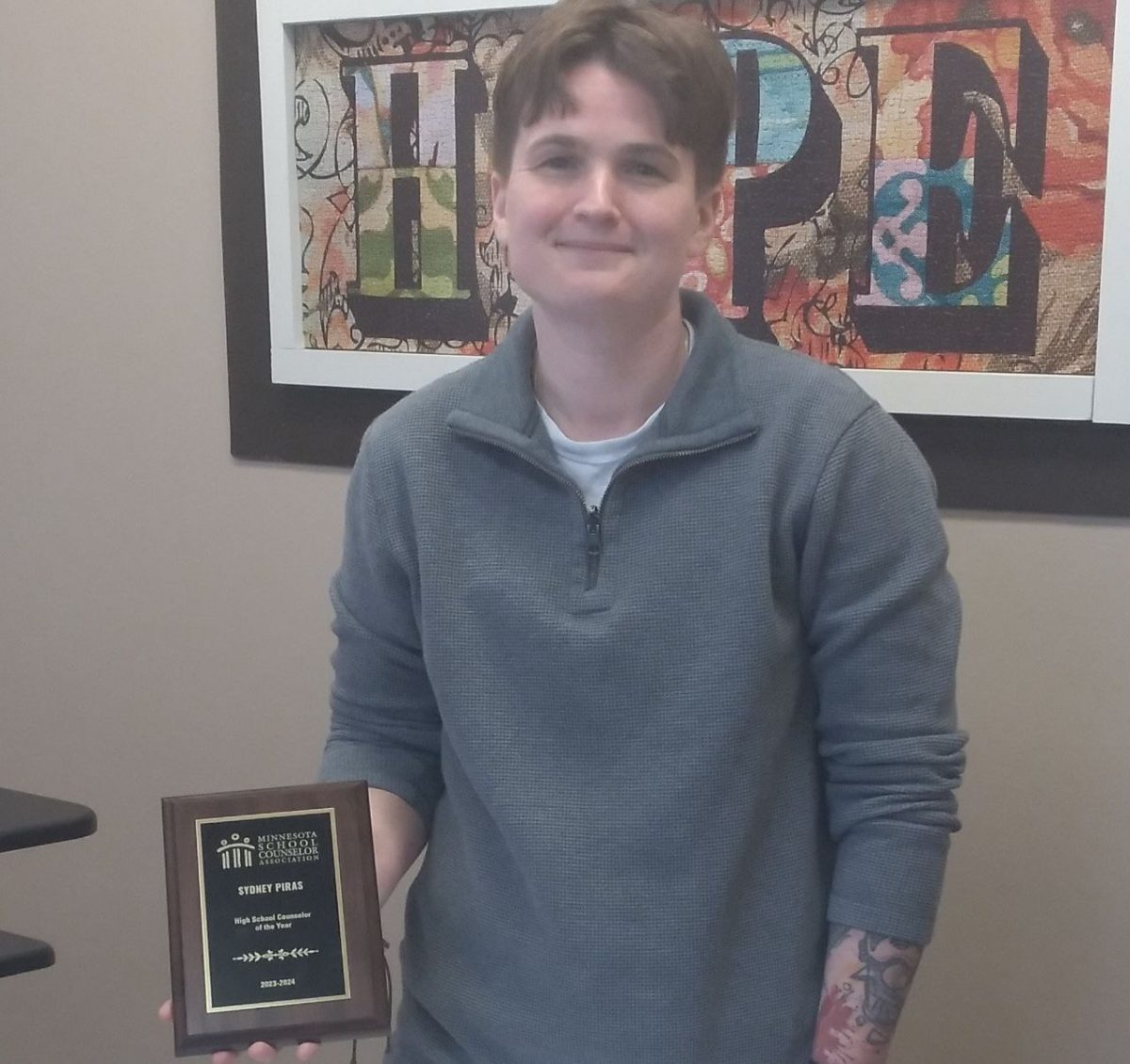 Counselor Sydney Piras holds the plaque she received when being named High School Counselor of the Year by the Minnesota School Counselor Association. Over her years as a school counselor, Piras has worked hard and  helped both students and schools grow.