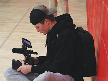 Senior Oren Hamilton records for a basketball game against Roseville. He is currently recording highlights for his Hamilton film.