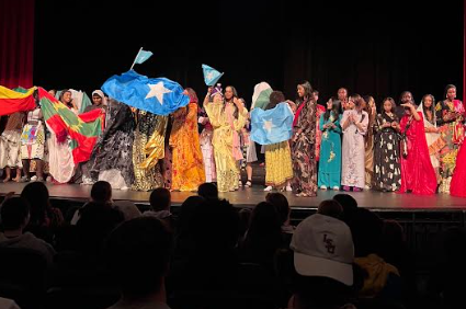 Participants after the annual Culture Runway Show wave their countrys flag with pride. Students partake in a Cultural Runway show and represent their countries. The audience saw a variety of traditions, dances and clothing practiced among their peers.