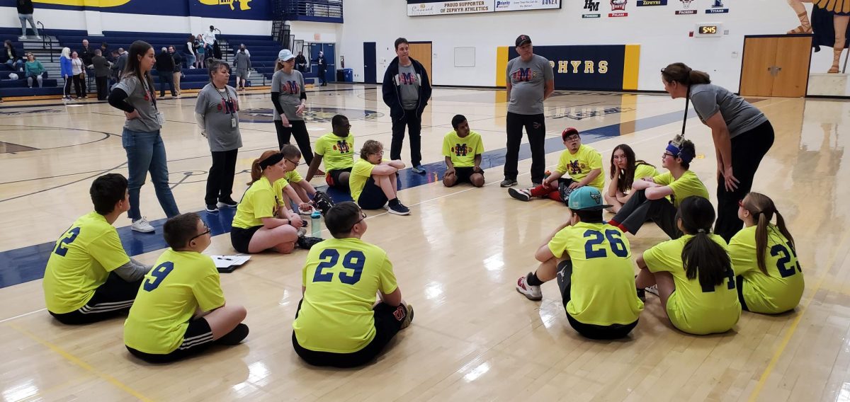 The adapted softball team gets a pep talk from head coach Suzanne Ericson after a close game on April 23.  They continue to improve their skills in only their second season as a team.