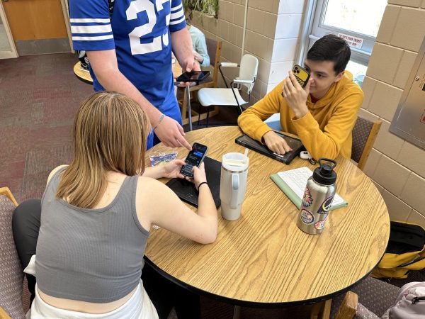 Students using smartphones at a table