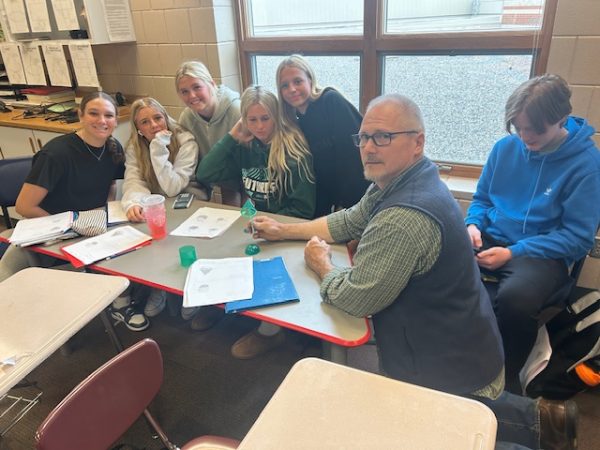 Math teacher Darby Whitehill reviewing with his first hour Geometry students. His approach on teaching is more interactive compared to just teaching them.