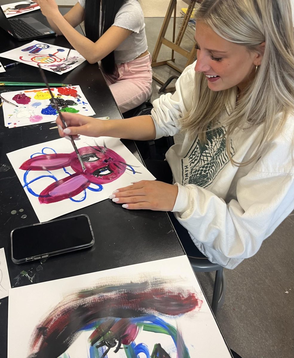 Junior Addyson Preuss paints a picture of a rabbit during class work time. Letting her creativity flow with painting the first thing that came to her mind.