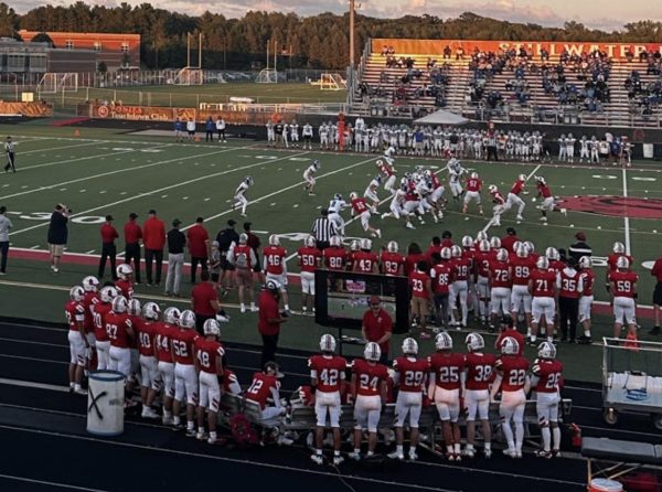 The football team watches videos in the middle of the game to help strategize any possible future plays. The team strategizes for the upcoming game on Oct. 17.