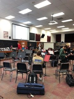 Students are preparing for the concert. The music director Tark Katzenmeyer directs the band. 