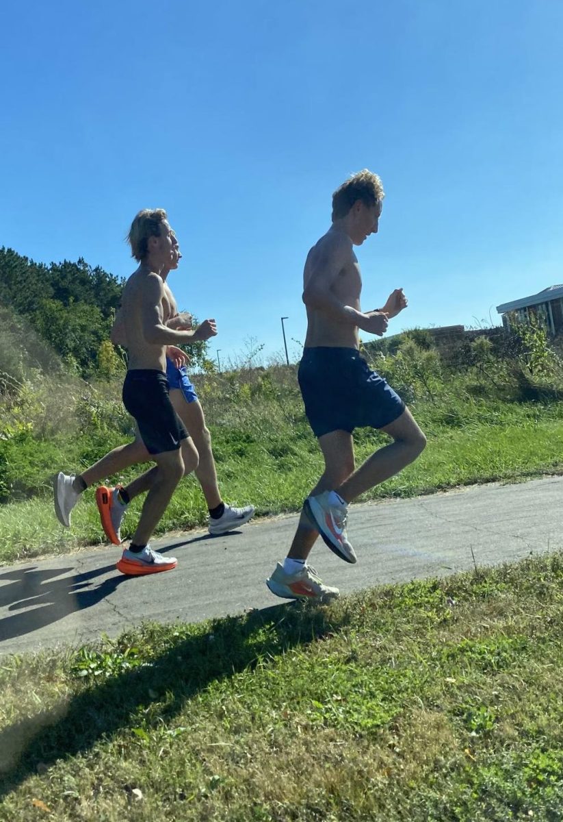 Senior captains Andrew Walsh and Dylan Riniker run during cross country practice. Running during practice is key to their team's success at meets.