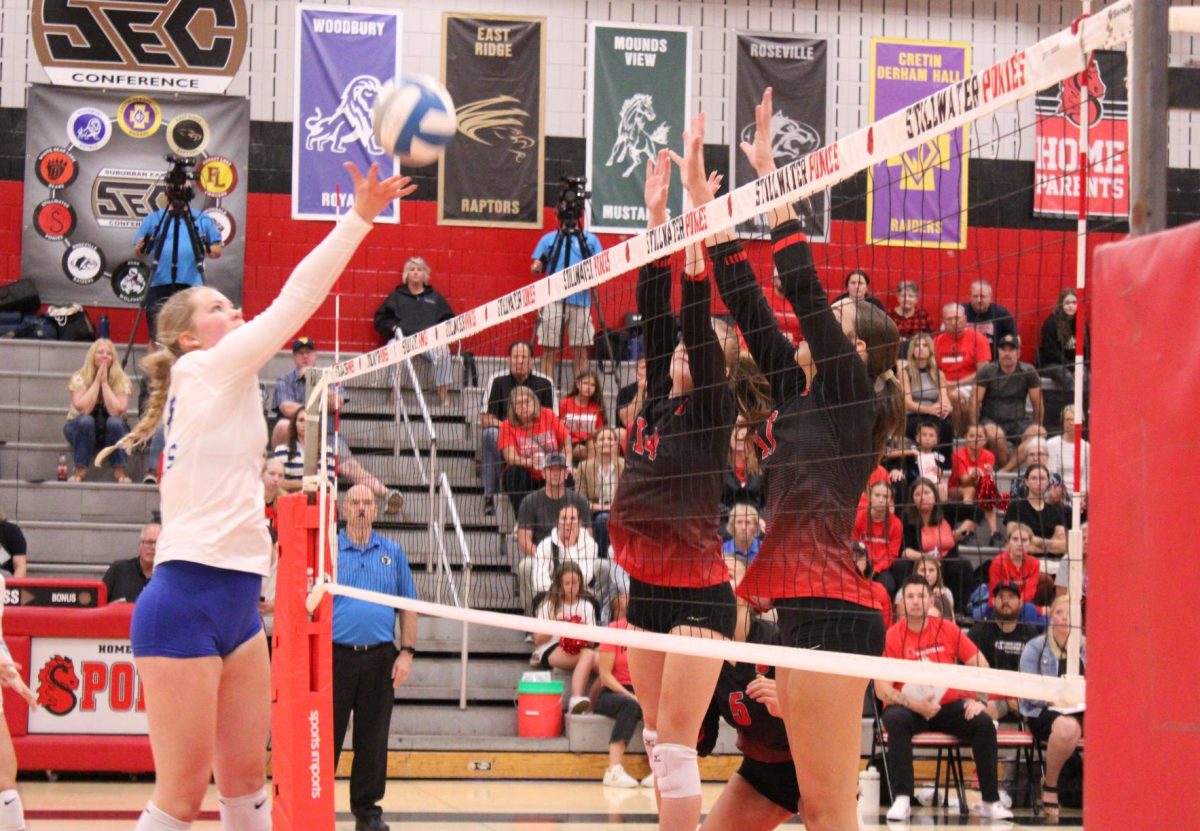 Juniors, Addison Brekke and Courtney Peters successfully block an incoming shot from the Woodbury Royals during a very intense point. This point won Stillwater the first match.