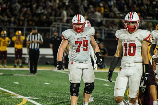 Sophomore Andrew Olsen looks towards the sidelines during a football game against Forest Lake on Sept. 27th. This shows Olsen playing football which is one of the two varsity sports he plays the other being wrestling.