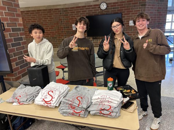 The new NHS sponsored bingo event taking place in the cafeteria during lunch. Members are in charge of the game and are testing the event out.