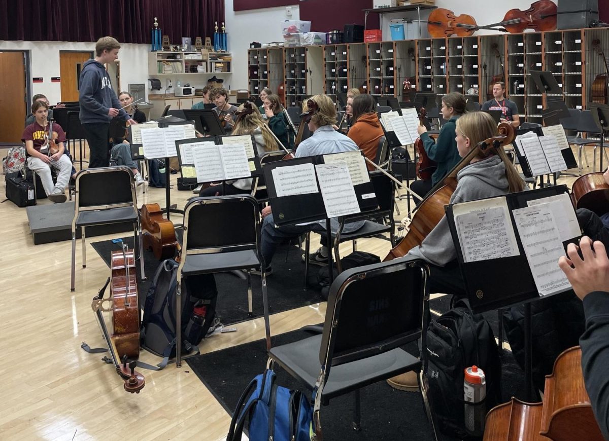 Junior Isaac Howard leads Concert orchestra rehearsal a week before the performance. He plans to conduct the second movement of Rutter's Suite for Strings for the concert. 