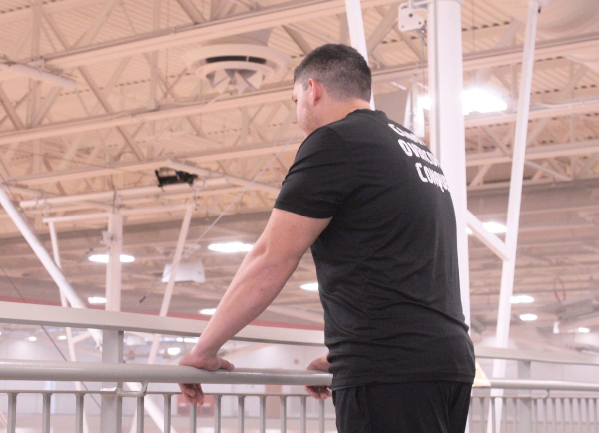 ETS coach Lucas Garbe looks over the track at his offseason basketball athletes. He trains them during their winter season, which is coming up in December.
"He's a great guy and it's good to see  him in the lair,"   junior Isaac Sainsbury said.