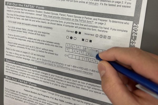 A student fills out a FAFSA application to see if applicable for student aid. Biden proposes student aid plan, which would lead to FAFSA being unnecessary.