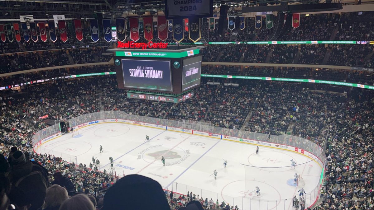 At the Xcel Energy Center Dec 3. Minnesota Wild take on the Vancouver Canucks. Players are on the ice warming up and preparing for the game.