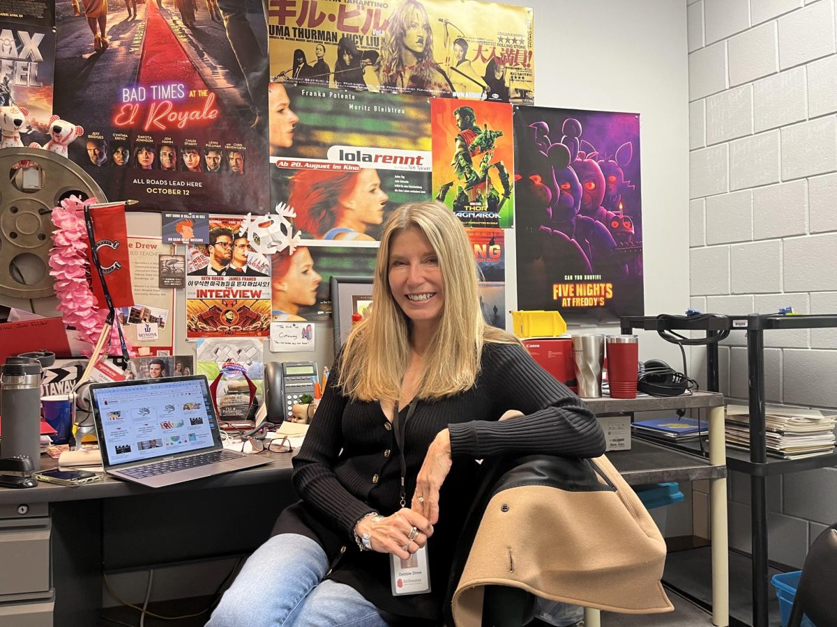 Video Production teacher Debbie Drew sits in her office planning for her new English and Film class. She is starting the class with her English colleague Andrew Smith.