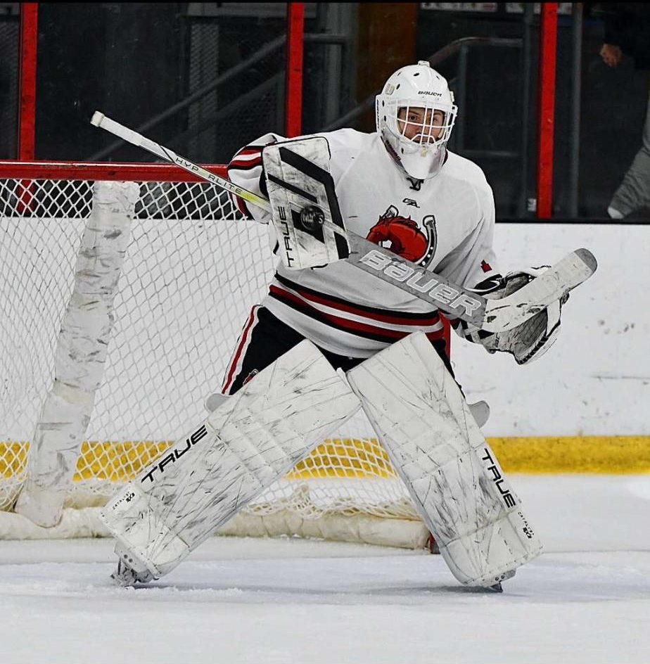 Senior goalie Cal Conway stands in the net ready for a shot in hopes of a big win against Eden Prairie on Dec. 3. He has a perfect save percentage of 1.0%.