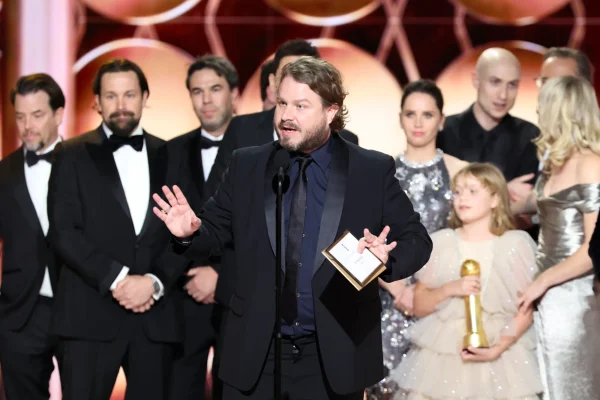 Brady Corbet accepts the award for his role in directing the film "The Brutalist". The movie was awarded best motion picture.  