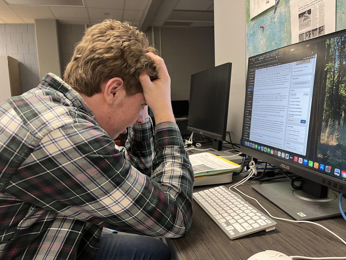 Junior Wesley Voigt works on an assignment. He feels that his stress levels have grown due to his workload.