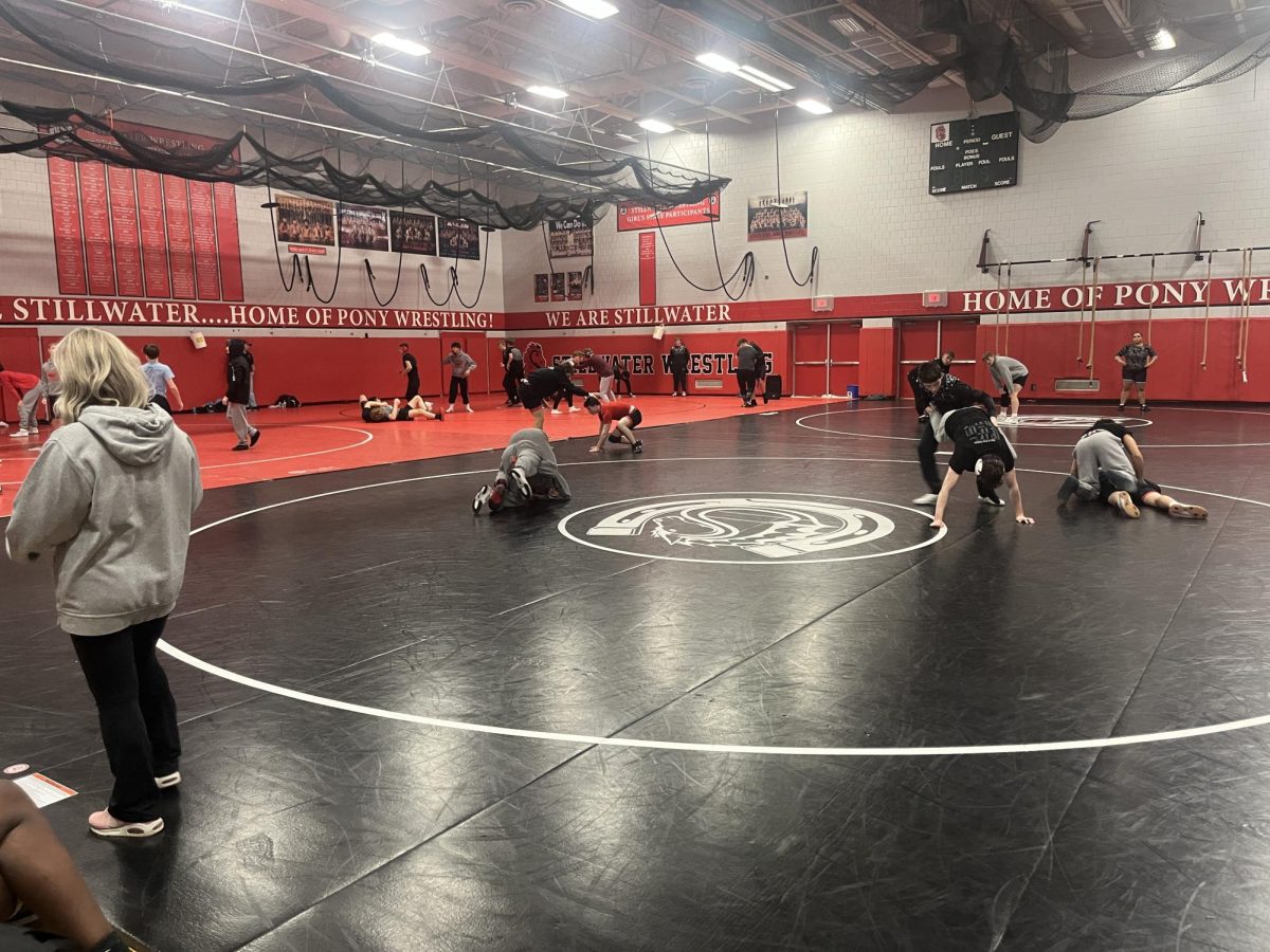 The girls and boys wrestling teams are warming up before a meet last Friday. This is the girls last duel meet before sections.