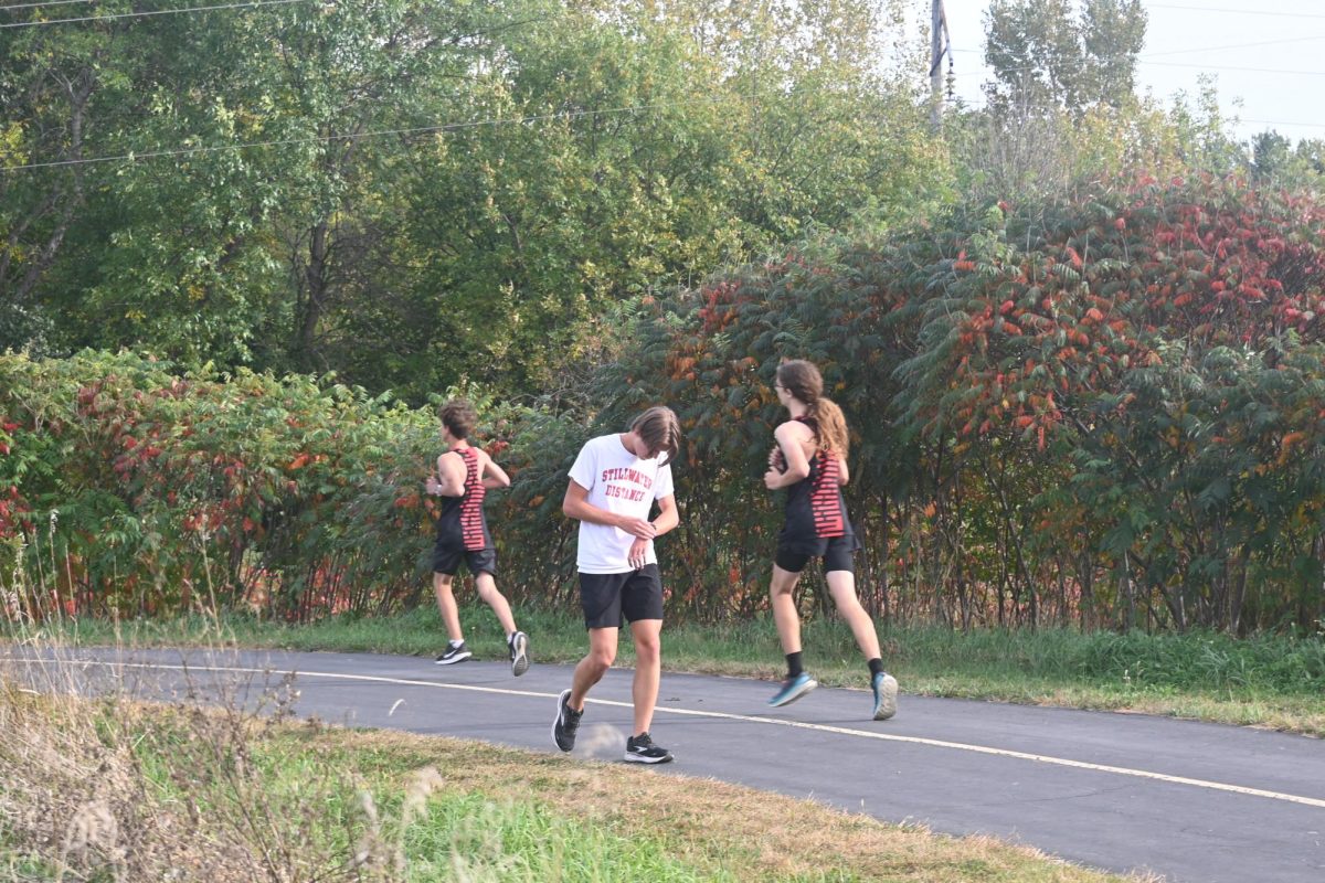 Junior Devin Christensen walks to prepare for his cross country meet. Christensen exercises daily to ensure he lowers his risk of injury when running.