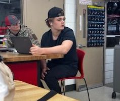 Mitchell Trisler, listens to country music as he finishes up an assignment. While he was doing this he was having a conversation with the metals  teacher about what he was doing. 