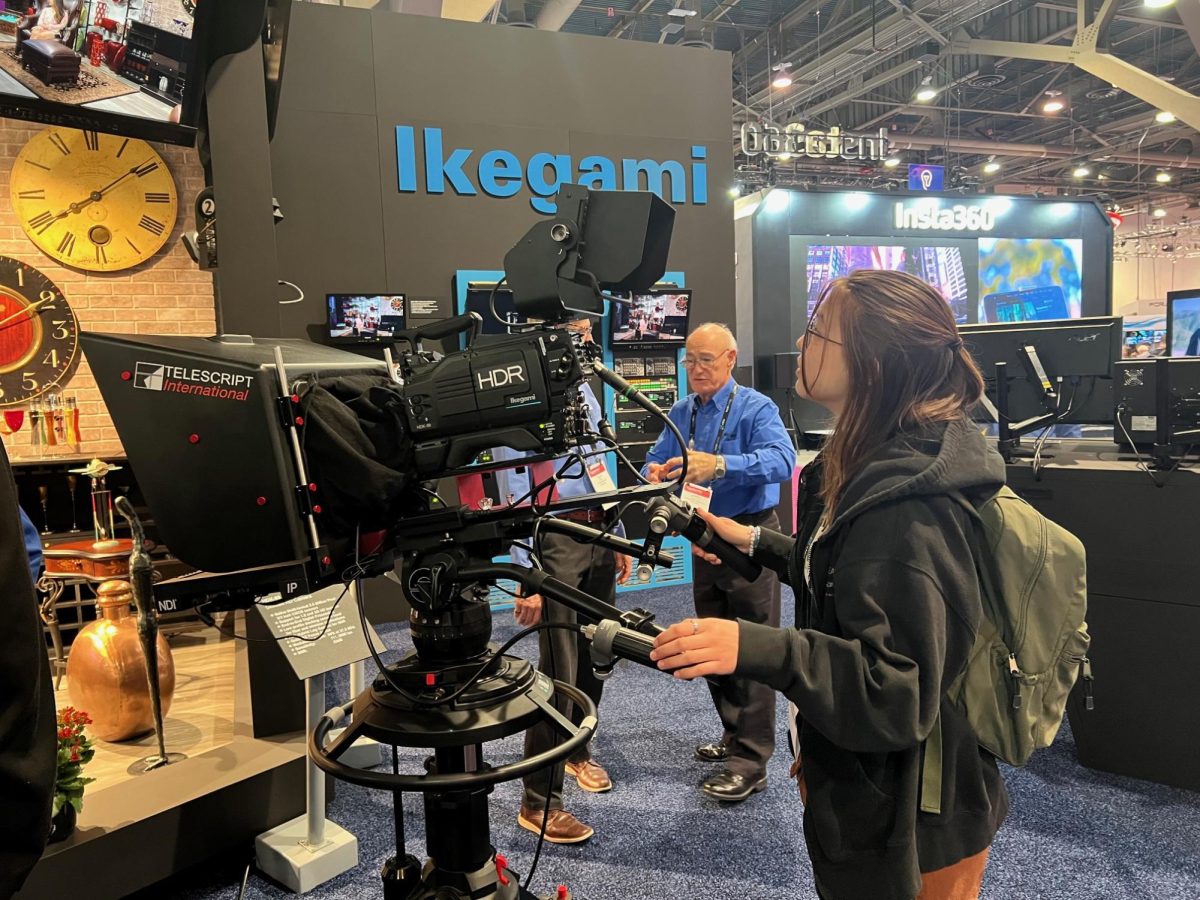 Stillwater alumni Genni Schroepfer explores the many exhibits and booths at the NAB convention. Her favorite part of the convention was getting to interact with the equipment.