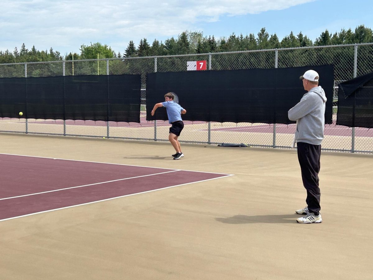 Coach Jay Knutson focused on a player's swing that he has been perfecting for months. He analyzed the body language of freshman Josh Severson to see where his head was at.