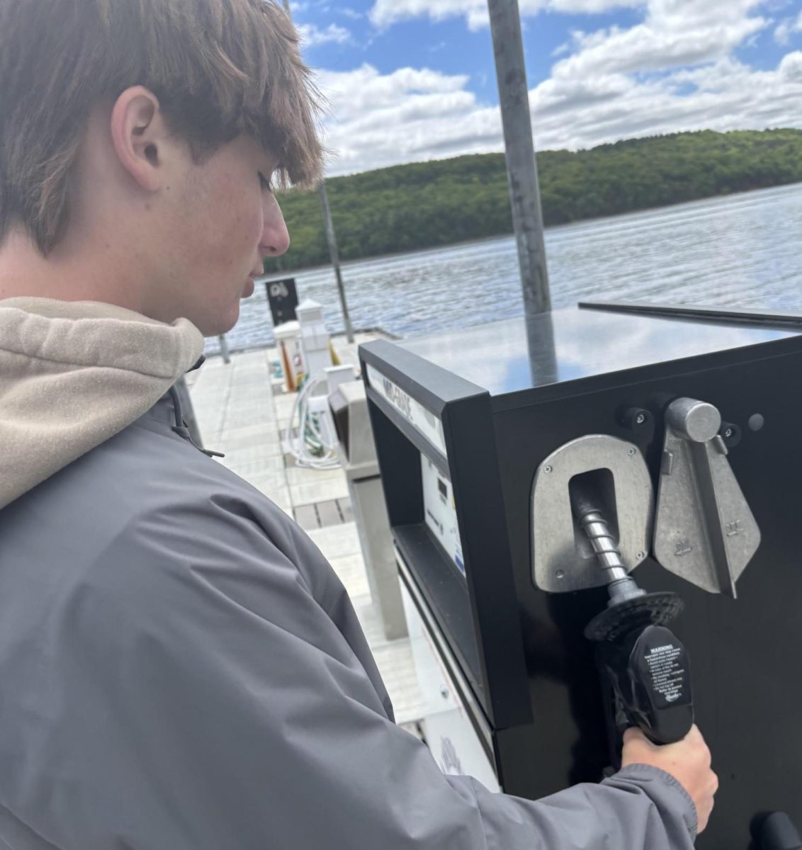 Sophomore Mason Braun works at Windmill Marina. He pumps gas into  member's boats, which is one of his many responsibilities at his job.