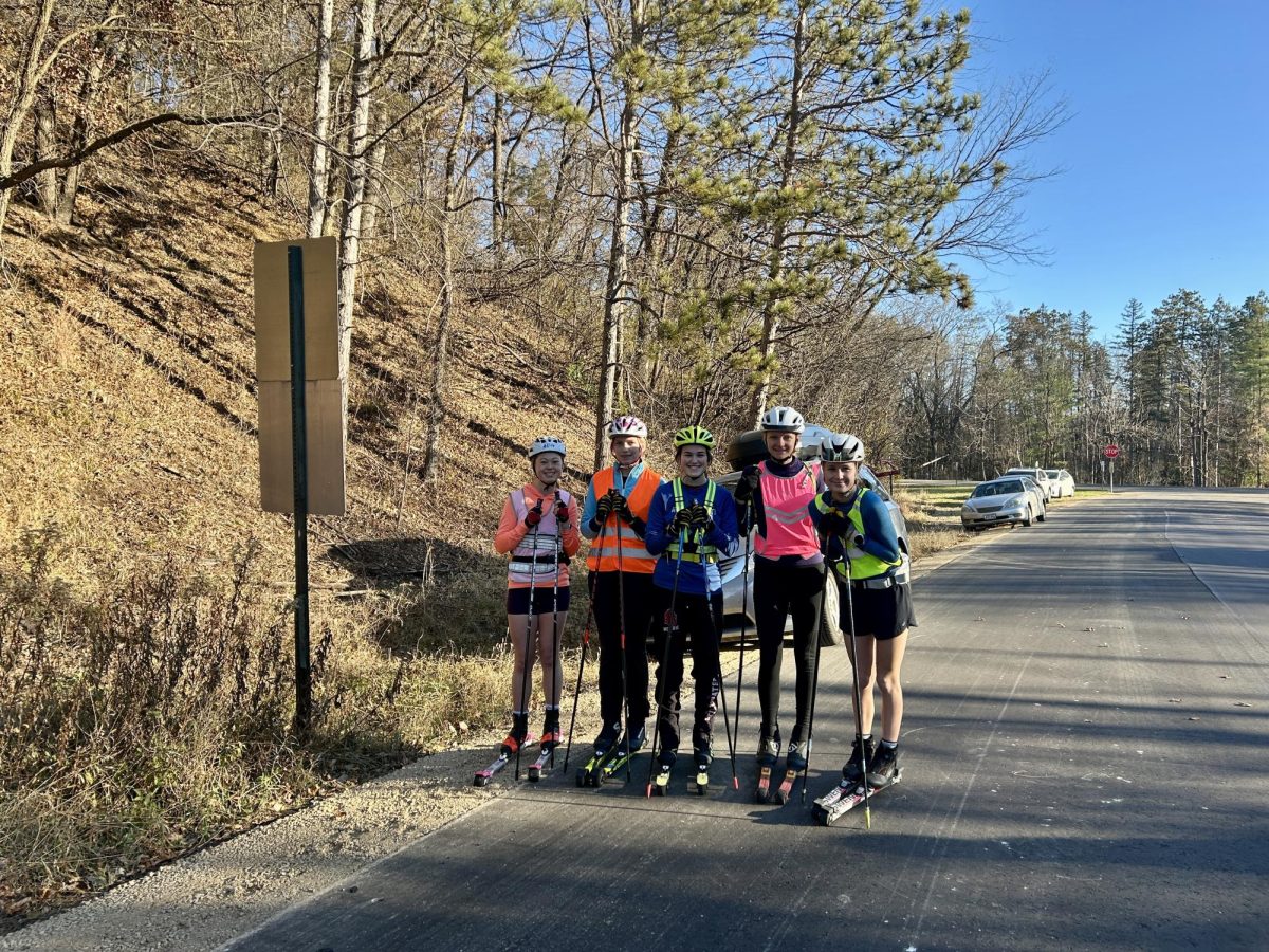 On Saturday, November 15, Stillwater Area High School students Ada Burns, Heidi Stoffregen, Anhalie Tepp, Greta Widenbrant, and Margurite Minich arrive in Afton, Minnesota, for an early morning practice. After taking a group picture with their roller skis, they prepare for a 2 to 3-hour distance roller ski to build a base and improve endurance.